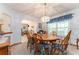 Cozy dining room with wood table set and a window with curtains, ideal for Gathering meals at 10159 Se 174Th St, Summerfield, FL 34491