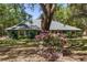Single story home with mature trees, flowering bushes, and a well-manicured lawn for outdoor enjoyment at 10159 Se 174Th St, Summerfield, FL 34491