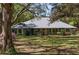 Charming single story home featuring a well-maintained lawn, mature trees, and welcoming front porch at 10159 Se 174Th St, Summerfield, FL 34491