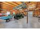 Large garage space with wooden ceiling, a garage door and vehicle inside at 10159 Se 174Th St, Summerfield, FL 34491