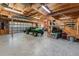 Large garage with natural wood framing and parked utility vehicle at 10159 Se 174Th St, Summerfield, FL 34491