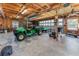 Spacious garage interior with wooden beams and various equipment at 10159 Se 174Th St, Summerfield, FL 34491