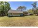 Garage exterior featuring a classic white garage door and manicured lawn at 10159 Se 174Th St, Summerfield, FL 34491