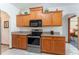 Kitchen with stainless steel appliances, wooden cabinets with countertops, and tiled floor at 10159 Se 174Th St, Summerfield, FL 34491