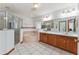 Bathroom featuring a large soaking tub, walk in shower and dual sink vanity offering a spa-like experience at 10159 Se 174Th St, Summerfield, FL 34491