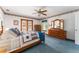Spacious main bedroom with carpet flooring, dresser, and private access to the outdoors at 10159 Se 174Th St, Summerfield, FL 34491