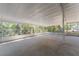 Large screened-in patio offering shaded outdoor living space with views of the surrounding greenery at 10159 Se 174Th St, Summerfield, FL 34491