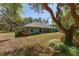 Charming blue home featuring a cozy patio and lush landscaping at 10159 Se 174Th St, Summerfield, FL 34491
