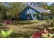 A charming blue house with a garage and a well-maintained yard at 10159 Se 174Th St, Summerfield, FL 34491