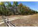 Spacious yard featuring mature trees and a rustic wooden fence, creating a peaceful and natural outdoor setting at 10159 Se 174Th St, Summerfield, FL 34491