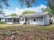 Image of the backyard featuring a screened in porch and well maintained lawn at 10323 Joanies Run, Leesburg, FL 34788