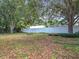 A large backyard with a white fence, offering privacy and security, perfect for outdoor activities and relaxation at 10323 Joanies Run, Leesburg, FL 34788