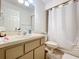 Standard bathroom with a vanity, toilet, and shower featuring a shower curtain at 10323 Joanies Run, Leesburg, FL 34788