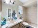 Well-lit bathroom featuring a large mirror, ample counter space, and tiled walk-in shower at 10323 Joanies Run, Leesburg, FL 34788