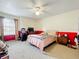 Bedroom with a ceiling fan, ample natural light, and neutral color palette at 10323 Joanies Run, Leesburg, FL 34788