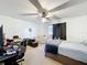Bright bedroom features a ceiling fan, plush carpet, and a cozy seating area at 10323 Joanies Run, Leesburg, FL 34788