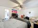 Spacious bedroom features a ceiling fan, plush carpet, and an en suite bathroom at 10323 Joanies Run, Leesburg, FL 34788