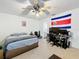 Bedroom featuring a bed, desk and chair, with a Costa Rican flag on the wall at 10323 Joanies Run, Leesburg, FL 34788