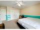 Bedroom with a white bed and light teal colored walls at 10323 Joanies Run, Leesburg, FL 34788