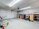 Spacious garage with ample storage space and a large garage door at 10323 Joanies Run, Leesburg, FL 34788