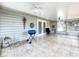 Enclosed lanai featuring tiled flooring, a ceiling fan, outdoor decor, and access to the backyard at 10323 Joanies Run, Leesburg, FL 34788