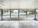 Enclosed lanai featuring tiled flooring, a ceiling fan, and views of the expansive backyard at 10323 Joanies Run, Leesburg, FL 34788