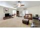 Comfortable living room featuring neutral walls, plush carpeting, ceiling fan, and furniture at 10323 Joanies Run, Leesburg, FL 34788