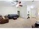 Inviting living room with vaulted ceiling, carpet, and plenty of natural light at 10323 Joanies Run, Leesburg, FL 34788