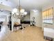 An open-concept living area showcasing tile floors and seamlessly connecting to the kitchen and dining spaces at 10323 Joanies Run, Leesburg, FL 34788