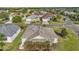 An aerial view of a home in a residential neighborhood near a lake at 1061 Woodruff St, The Villages, FL 32162