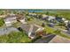 An aerial view of a home in a residential neighborhood, with a view of a nearby lake at 1061 Woodruff St, The Villages, FL 32162