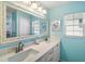 Bathroom featuring a double vanity, large mirror, and soft lighting at 1061 Woodruff St, The Villages, FL 32162