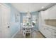 Bright breakfast nook with tile flooring, a round table, and a charming chandelier at 1061 Woodruff St, The Villages, FL 32162