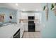 Well-lit kitchen featuring white cabinets, quartz countertops, and modern appliances at 1061 Woodruff St, The Villages, FL 32162