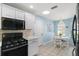 Bright eat-in kitchen features white cabinets, stainless appliances, and a charming chandelier at 1061 Woodruff St, The Villages, FL 32162