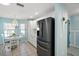 Cozy eat-in kitchen boasts a modern fridge and is illuminated by a decorative chandelier at 1061 Woodruff St, The Villages, FL 32162