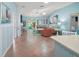 Bright, open living room with tile floors, and access to outdoor patio at 1061 Woodruff St, The Villages, FL 32162