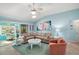 Open living room featuring tile flooring, a fan, and comfortable seating at 1061 Woodruff St, The Villages, FL 32162