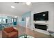 Bright living room with tile floors, a modern fireplace, and a view of the dining area at 1061 Woodruff St, The Villages, FL 32162