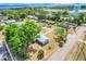 An aerial view of single-story house in a neighborhood, with tree-lined streets and mature trees at 1109 Hampton St, Clermont, FL 34711