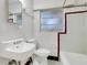 Vintage bathroom with a tiled shower and a classic white sink and toilet at 1109 Hampton St, Clermont, FL 34711