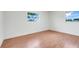 Cozy bedroom featuring hardwood floors, white walls and dual windows at 1109 Hampton St, Clermont, FL 34711