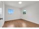 Bright bedroom features hardwood floors and two windows with natural light at 1109 Hampton St, Clermont, FL 34711
