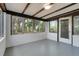 Bright sunroom with expansive windows, white block walls, and wood-beamed ceiling at 1109 Hampton St, Clermont, FL 34711