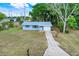 Charming single-story home with an attached garage, driveway, and well-maintained lawn at 1109 Hampton St, Clermont, FL 34711