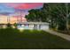 Charming single-story home with a well-manicured lawn, mature trees, and an attached one car garage at 1109 Hampton St, Clermont, FL 34711