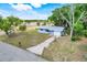 Inviting single-story home with a well-maintained lawn, mature trees, and attached garage at 1109 Hampton St, Clermont, FL 34711