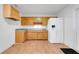 Classic kitchen with wooden cabinets, white refrigerator and matching countertops at 1109 Hampton St, Clermont, FL 34711