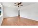 Bright living room with hardwood floors, ceiling fan, and fresh paint at 1109 Hampton St, Clermont, FL 34711