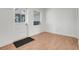 Bright living room with wood-look floors, white walls, and a door to the backyard at 1109 Hampton St, Clermont, FL 34711
